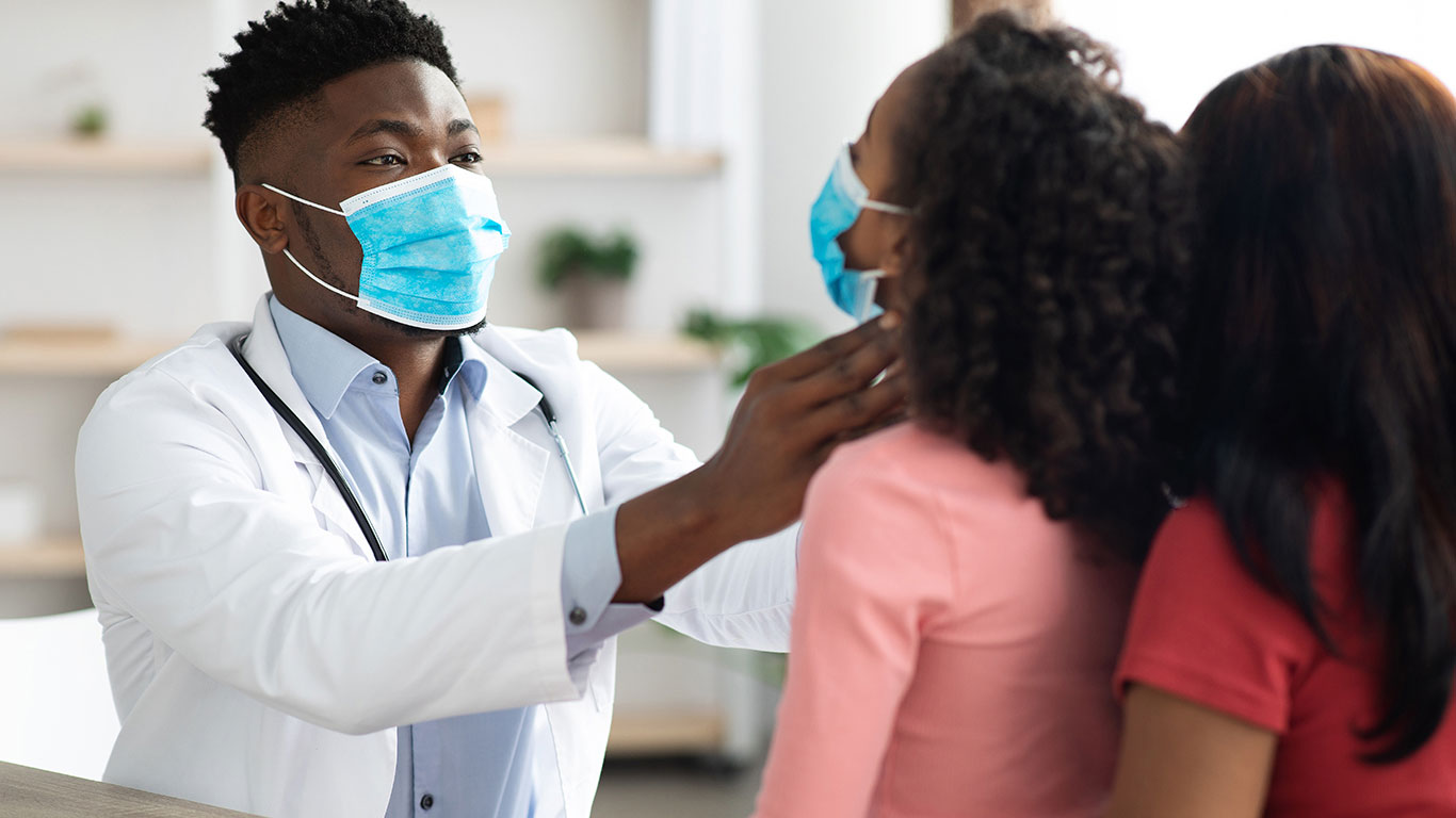 black-doctor-in-face-mask-checking-little-patient-2022-08-10-18-43-55-utc